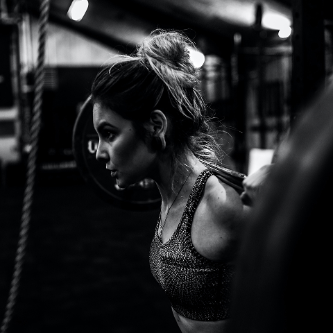 the girl lifts a dumbbell