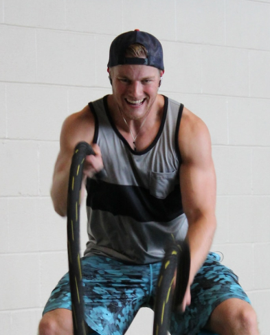 a man trains his arms with ropes